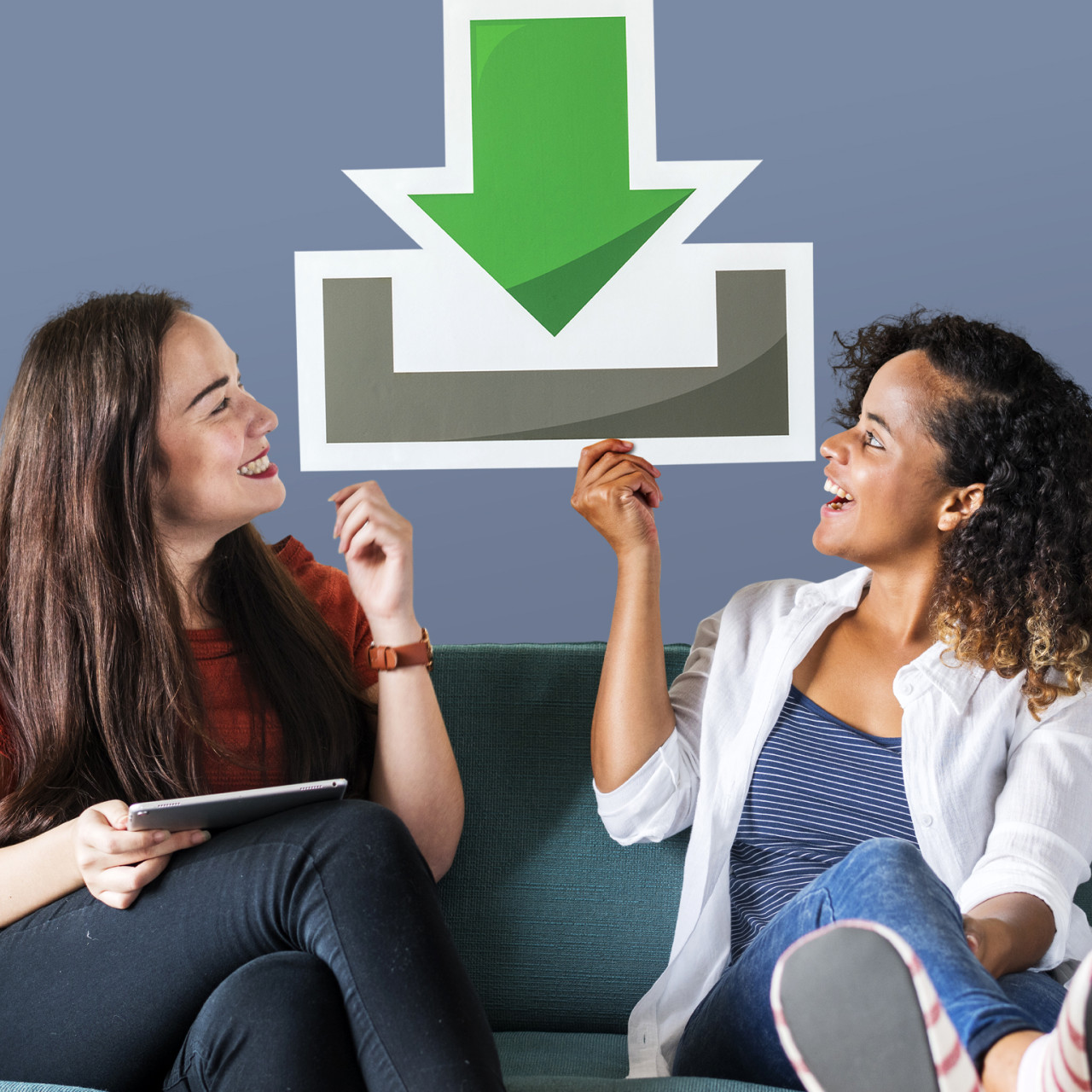 Photo of women holding a cardboard cutout of a download icon.