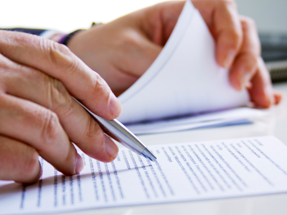 Photo of a businessman reviewing a document.